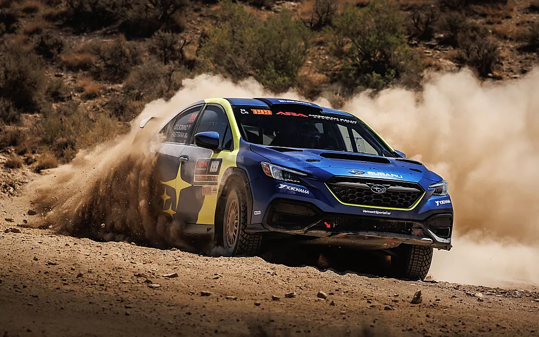 Subaru rally car speeding on gravel road